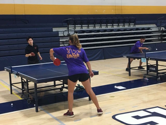 A women's club table tennis team member plays a match.