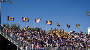 HSU football fans in the stands wearing school colors