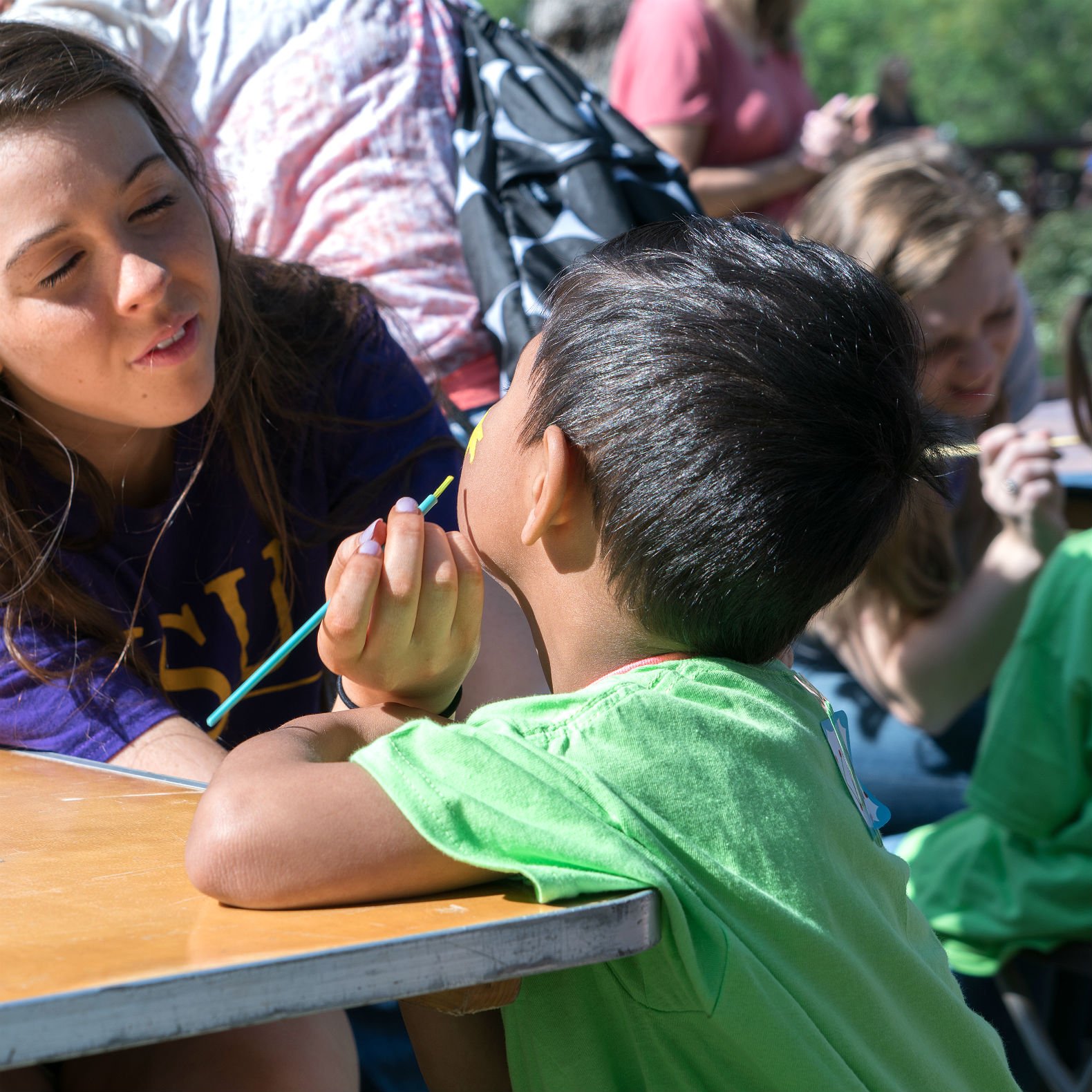 Photo of children getting paint on face