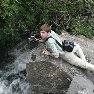 Photo of environmental student taking photo on a rock