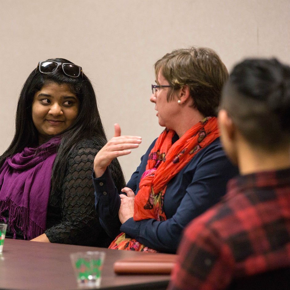 Photo of international faculty talking in a conference.