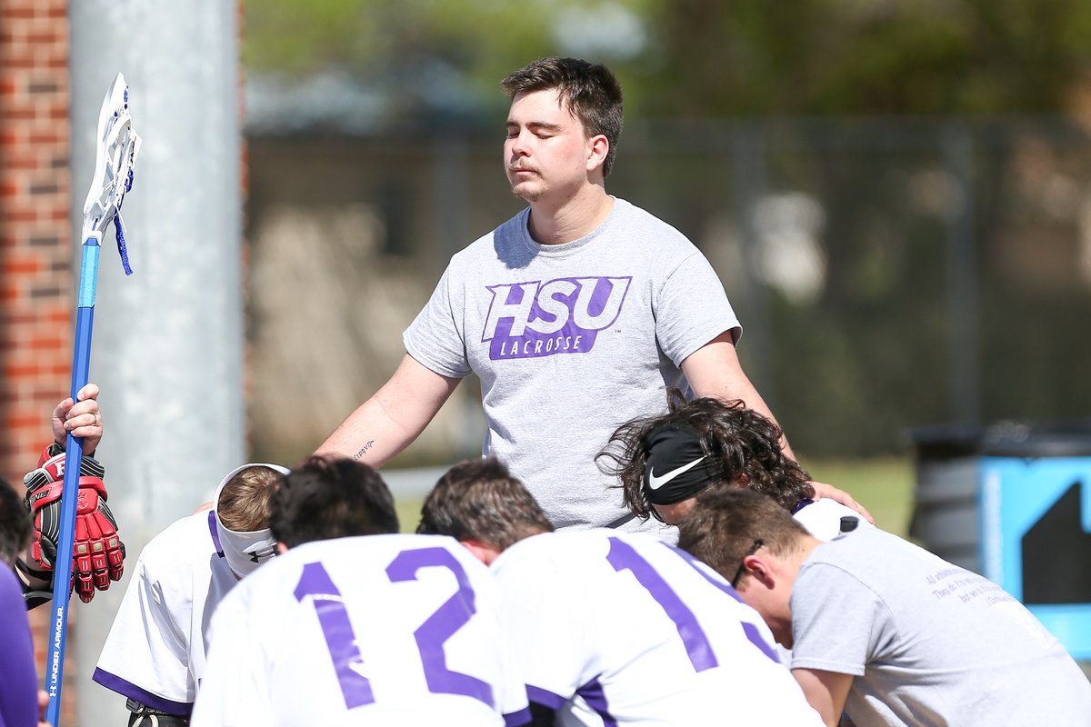 HSU men's club lacrosse team prays before a match.