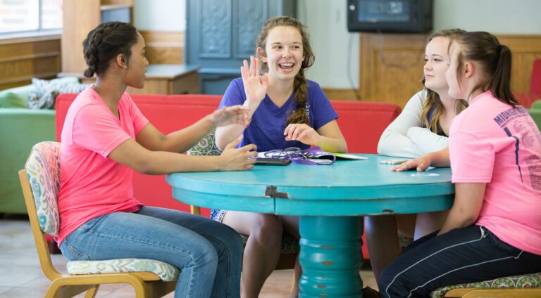 Female HSU students conversing in a residential hall.