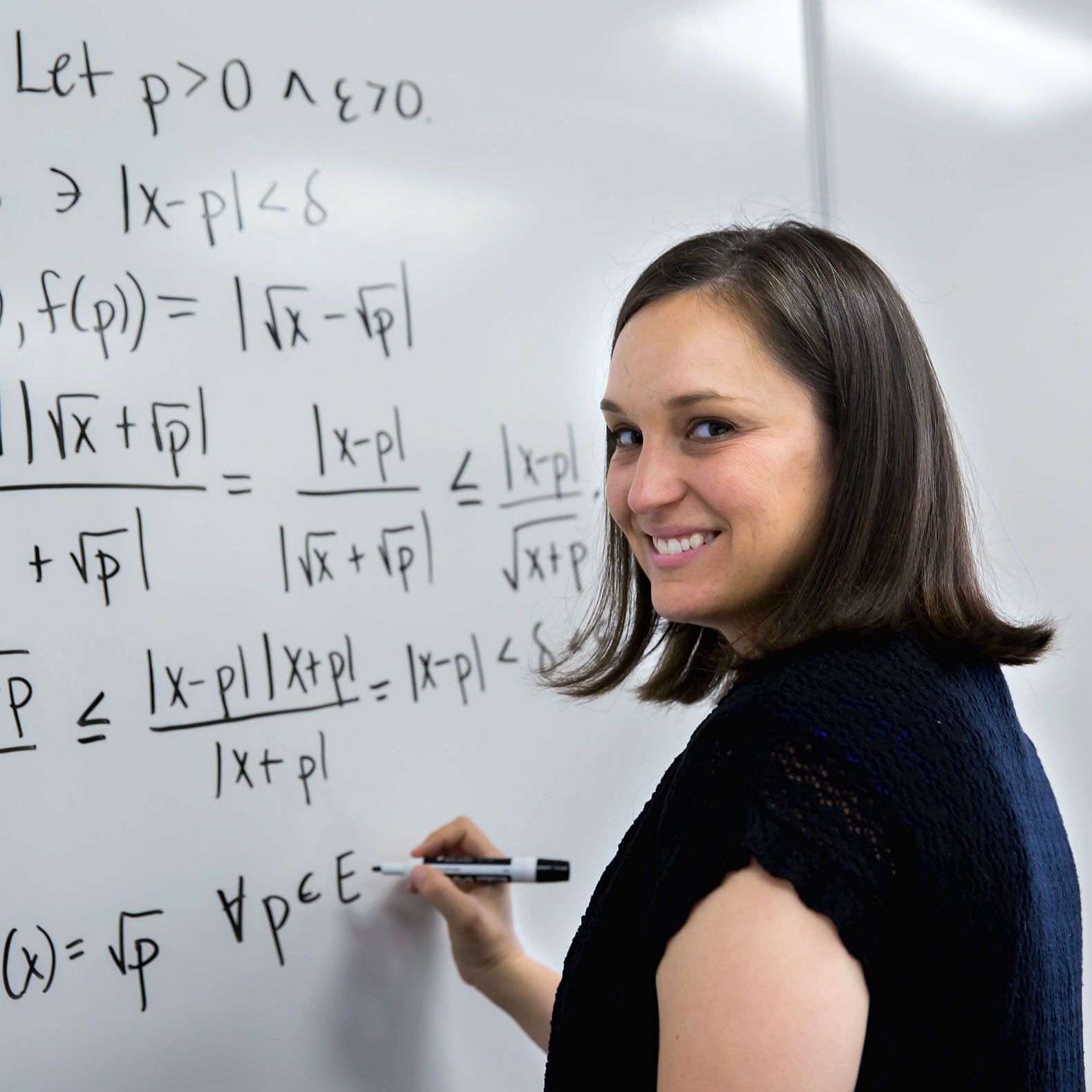 HSU professor solving calculus problem on a whiteboard