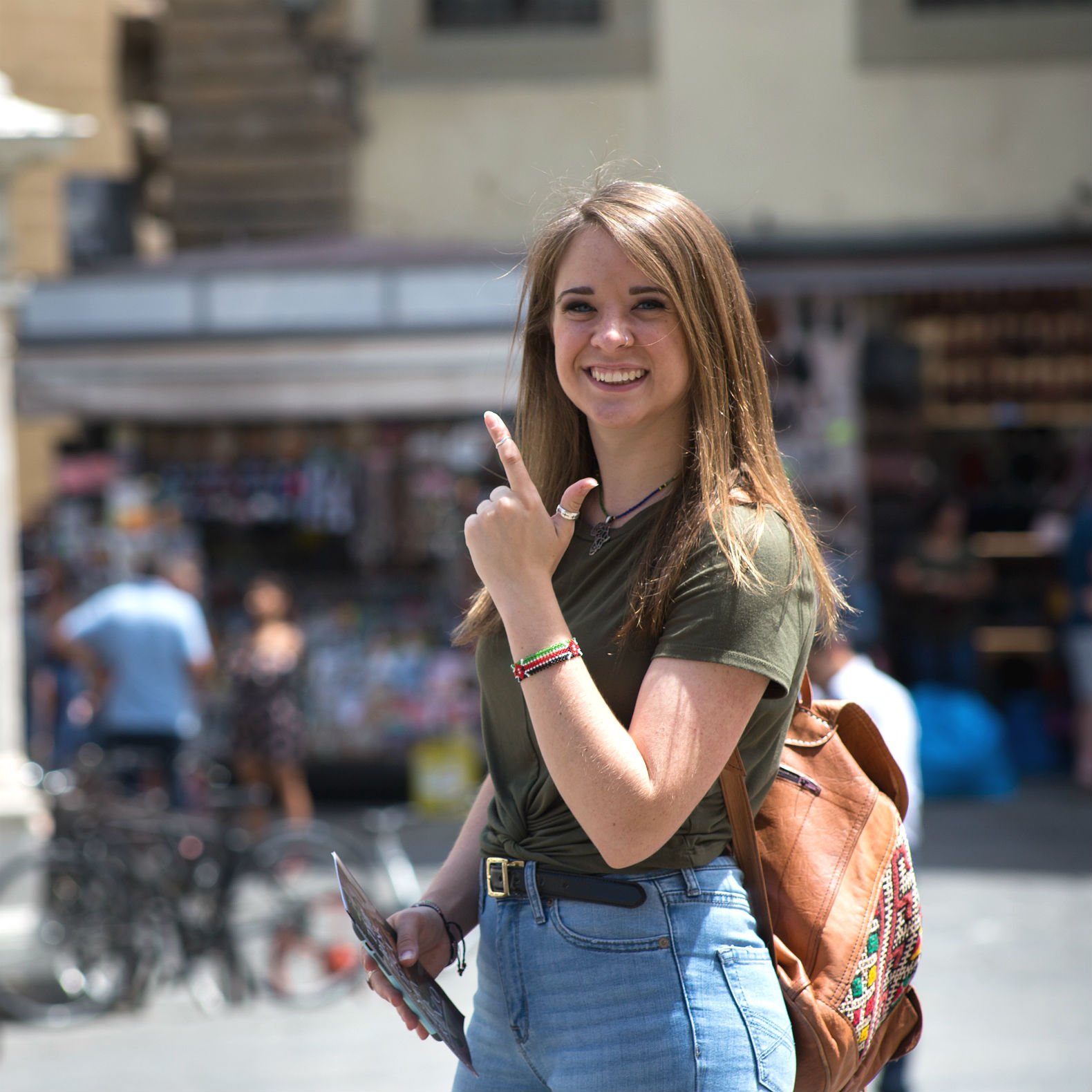 HSU student on campus giving the school hand sign