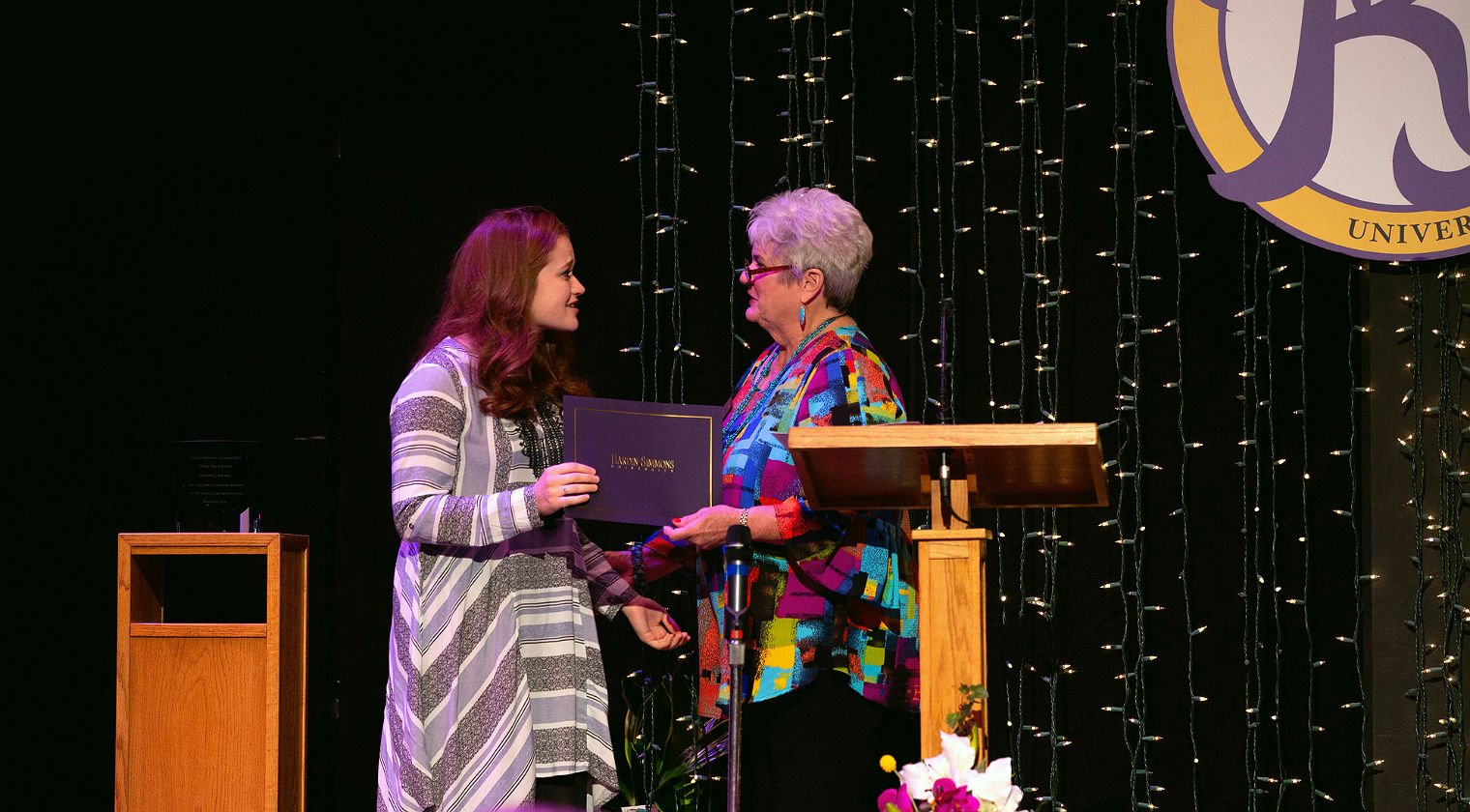 Professor and student on stage at HSU Round Table