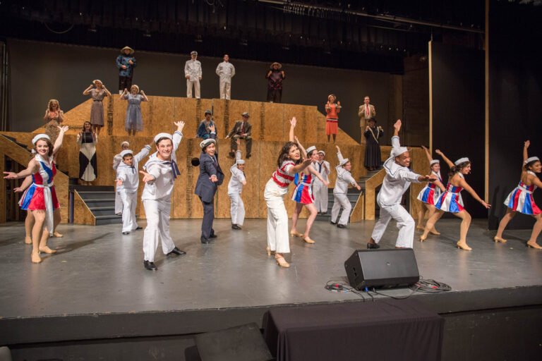 HSU theater students singing in costume on stage