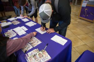 Students sign postcards at Thank a Donor Day in 2017.