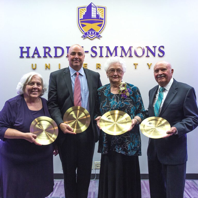 2018 Alumni Award recipients show their awards.