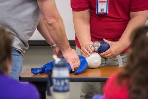 A PHSSN student learns infant CPR.