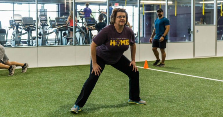 A woman doing group exercise.