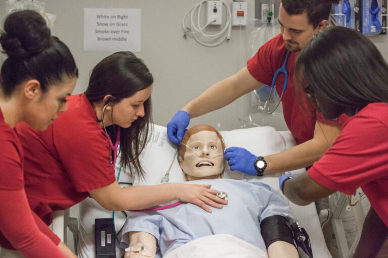 Students at PHSSN practice their skills on a mannequin.