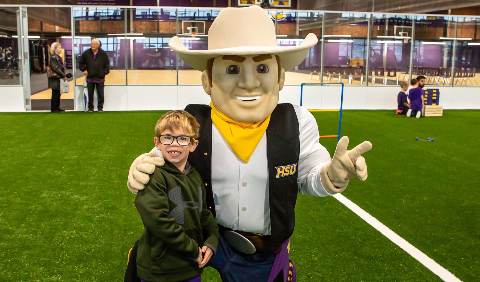 Hoss poses with a young member of the HSU family