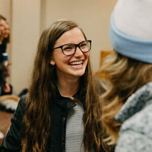 A smiling female student at a campus event.