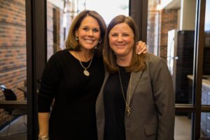 Jackie Baugh Moore poses with Dr. Meredith Stone in front of the door to the new lounge.