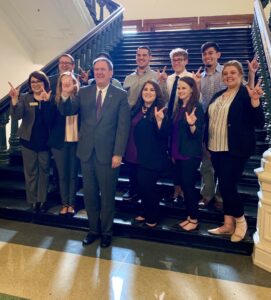 Students hold their HSU guns up with Representative Stan Lambert.