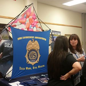 Criminal justice students talk to a potential employer at a job fair.