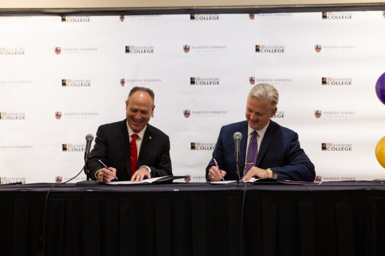Dr. Eric Bruntmyer, president of HSU, and Dr. Tod Allen Farmer, president of Weatherford College, sign the articulation agreement, which will allow students to transfer more easily between the two schools.