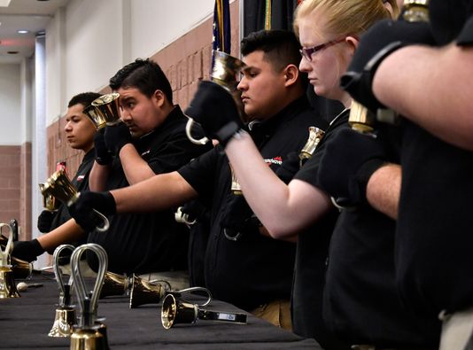 Members of the Soundwave Handbell Choir focus on their music.