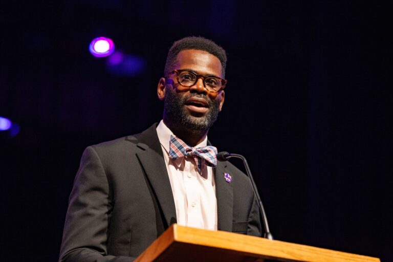 Dr. Travis Craver speaks at a university event.