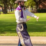 2018 Drum Major, Bret Hudman, leads the band during the parade.