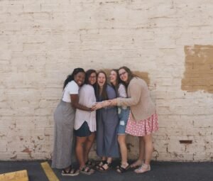 Showing love with laughter and hugs, the resident assistants pose for a group picture.