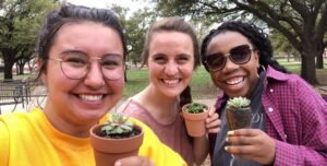 Resident assistants pose with their succulents after a successful garden party on Anderson lawn.