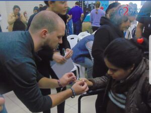 Joe in Peru praying over one of the individuals who received a wheelchair