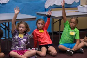 Threshold students are eager to answer their teacher's question.