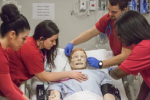 Patty Hanks Shelton School of Nursing students tend to a mannequin patient.
