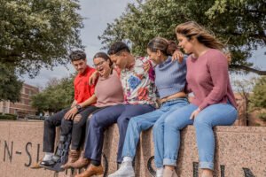 Last year's officers laugh during a photo session on the Hardin-Simmons University sign.