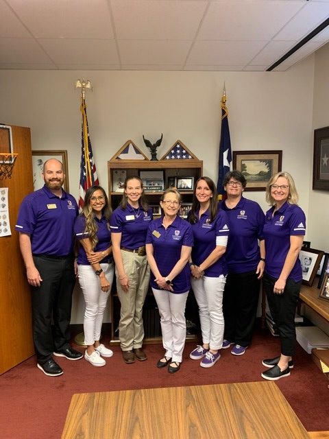 course pose together in the Texas State Capitol building