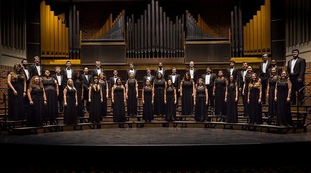 The HSU Concert Choir stands at attention onstage.