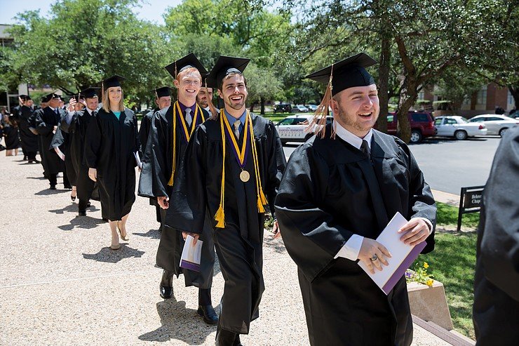Photo of graduates walking.
