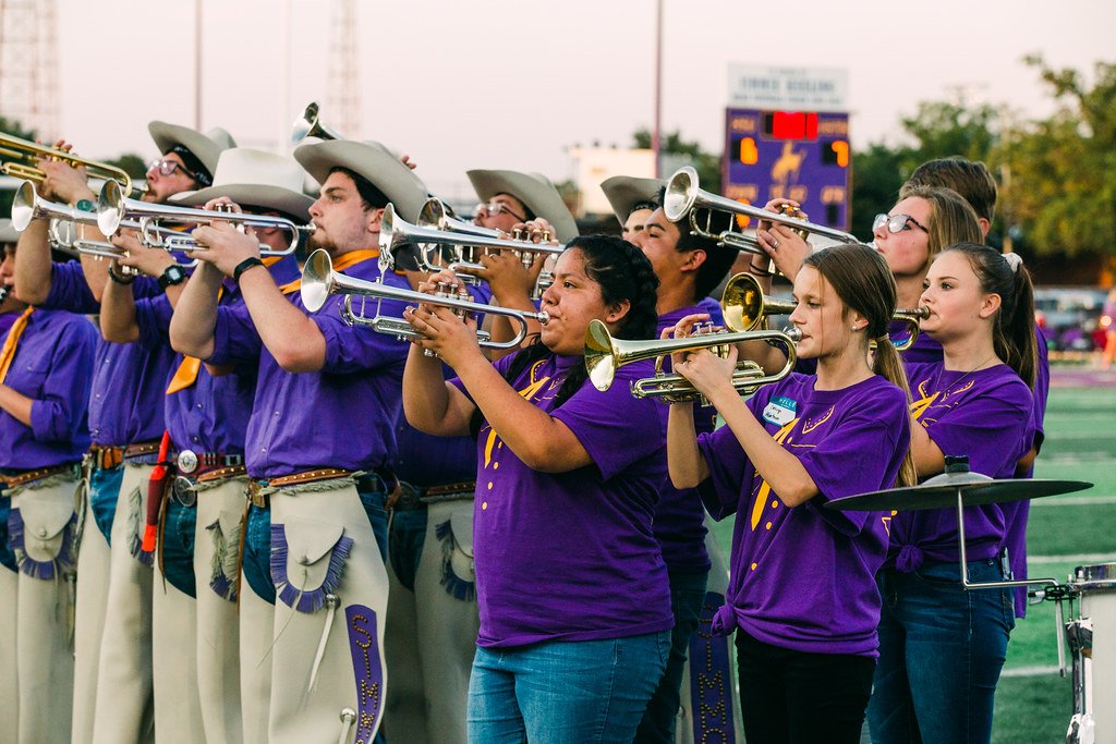 Over 60 high school students, dressed in Cowboy Band inspired t-shirts, played alongside the cowboy band last Saturday.