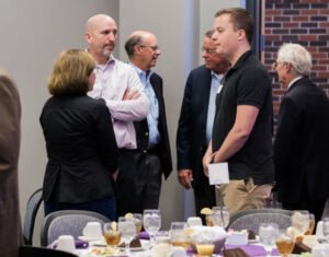 Logan Ingram, a senior at HSU, speaks with local business professionals at the Ray Lewis Lectures.