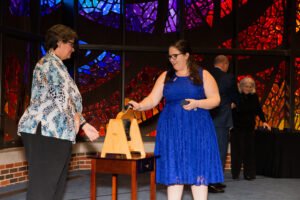 Celebrating the receiving of her HSU ring, Grace Thompson rings the tradional bell.