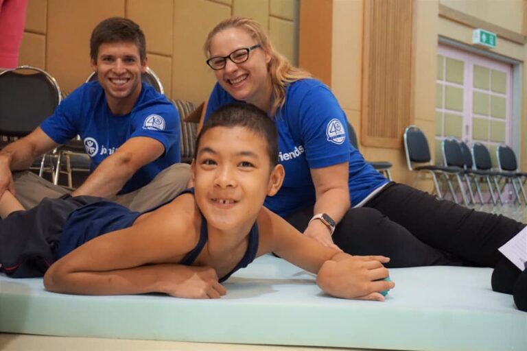 HSU PT students fit children with mobility devices in Thailand last summer.