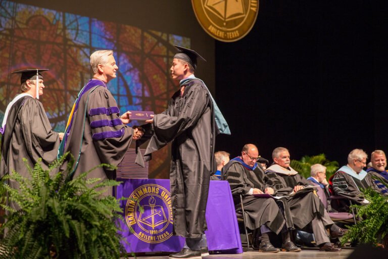 A student is awarded his diploma from President Eric Bruntmyer during a Spring 2019 Commencement ceremony.