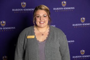 New to the 2019 Etiquette Dinner was the addition of professional headshots. Here, staff writer Macee Hall poses for her headshot in front of a Hardin-Simmons backdrop.