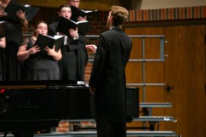 Brandon Allen conducts the Concert Choir during its performance.