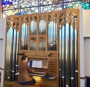 Julia Tucker plays the organ at Valley Presbyterian Church, where she serves as the organist and director of music.