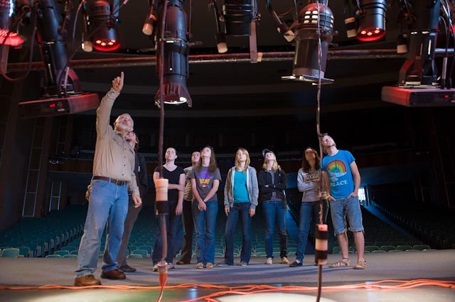 Larry Wheeler speaks to a group of students about the lighting in Van Ellis Theatre.