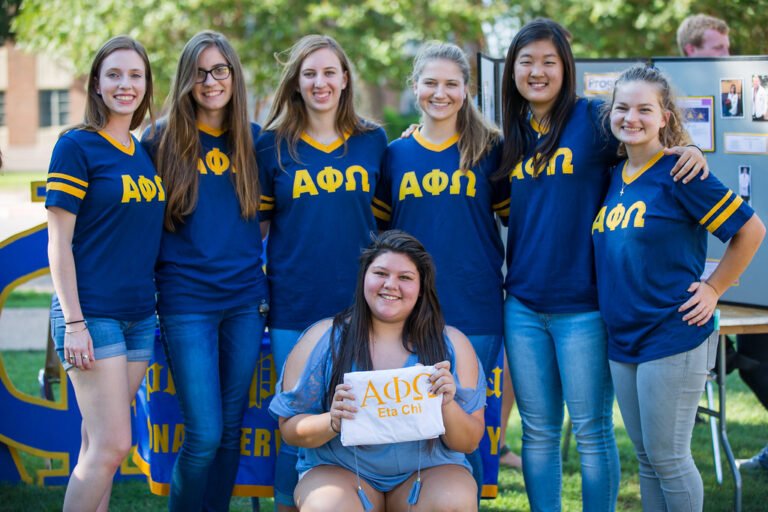 Members of Alpha Phi Omega support their organization at a Fall 2017 info fair.