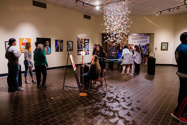 Students enjoy a Kappa Pi art show in the Ira M. Taylor Gallery in the Frost Building.