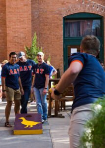 The men of Lambda Alpha Tau play cornhole, a favorite among HSU's Greek clubs.