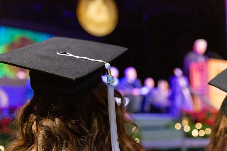 Students line up to receive their diplomas from President Eric Bruntmyer.