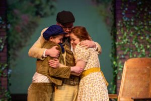 The family in “The Secret Garden” comes together for a celebratory hug.