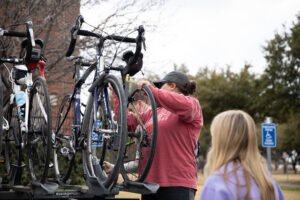 Senior Ryanne Krueger unloads a bike upon returning from the 2019 bike ride.