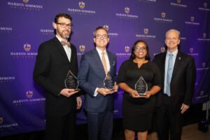 Dr. Eric Black, Mr. David Krake, and Ms. Vishia Wilson pose with President Eric Bruntmyer after recieving their OYA awards.